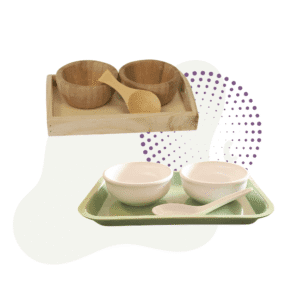 The Spooning Set with Spoon includes a wooden tray with two wooden bowls and a scoop, plus a green tray with two white bowls and a white spoon.