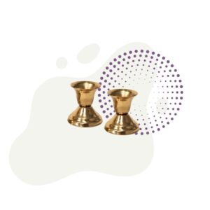 A set of brass candle holders on a white background.