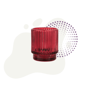 The Candle Holder, Sanctuary is a short, cylindrical red glass with vertical ridges, shown in front of abstract cream and purple shapes on a white background.