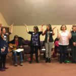 a group of people standing in a room.