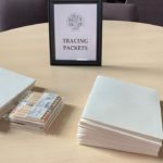 a table topped with stacks of cards and a picture frame.