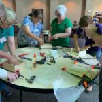 a group of older people working on a project.