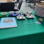 a table with a green table cloth and a green table cloth.