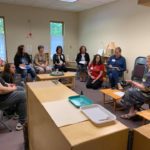 a group of people sitting in a classroom.