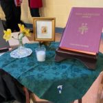 a person sitting at a table with a book on it.