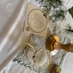 a table topped with a bottle of wine and a card.