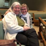 a couple of women sitting next to each other.