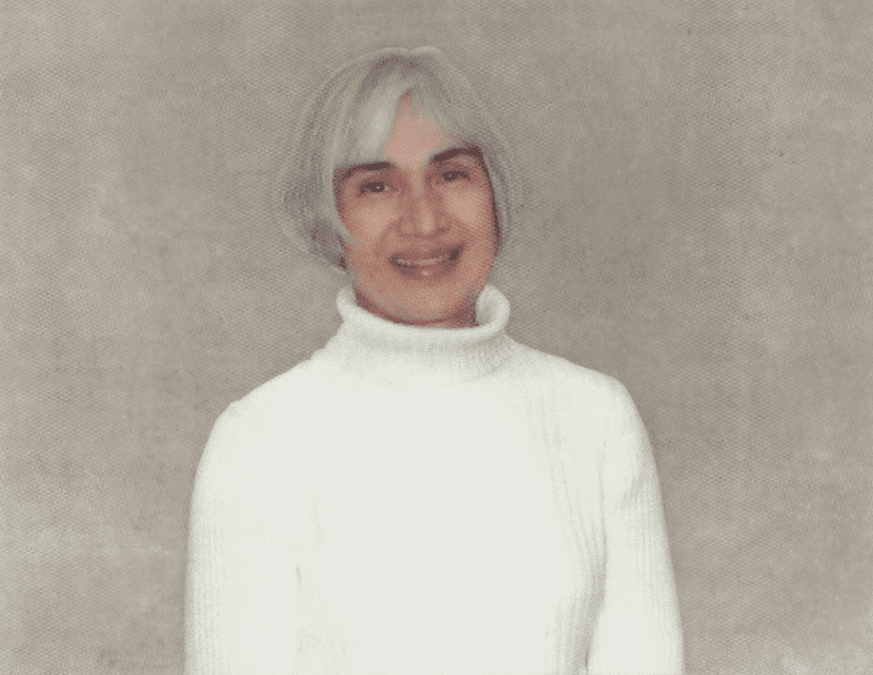 a woman with grey hair and a white sweater.