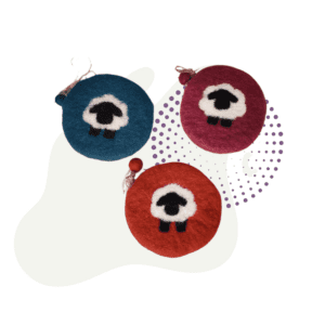 Three colorful felt Toddler Zipper Pouches with abstract eye designs in blue, red, and maroon placed on a white background with purple dotted accents.